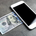 smartphone and 100 dollar bill