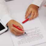 woman proofreading and highlighting document