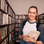 woman holding books in library
