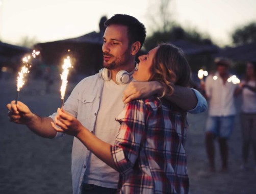 happy couple holding sparklers