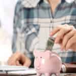 woman saving money in her piggy bank